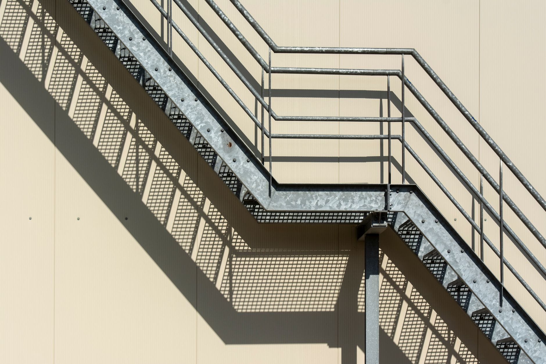 Nowoczesne stalowe schody wewnętrzne rzucające geometryczne cienie